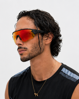 Athlete wearing the Crandon anti-fog sport sunglasses after a session, sweat-damp hair, three-quarter view