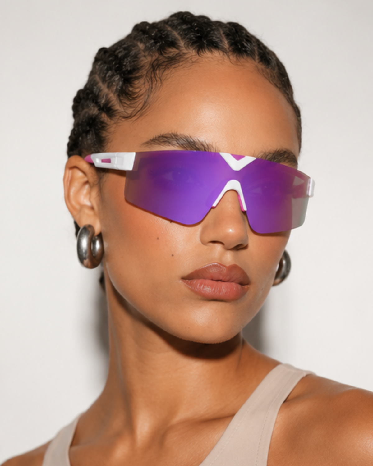 Woman wearing Surfside light-adaptive sunglasses, front view showing the shield lens spanning both eyes with no lower rim