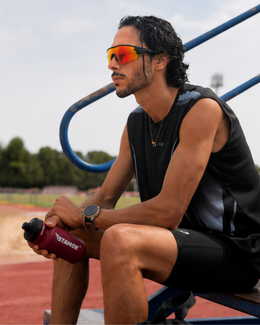 Runner resting trackside in humid conditions wearing the Crandon anti-fog sunglasses